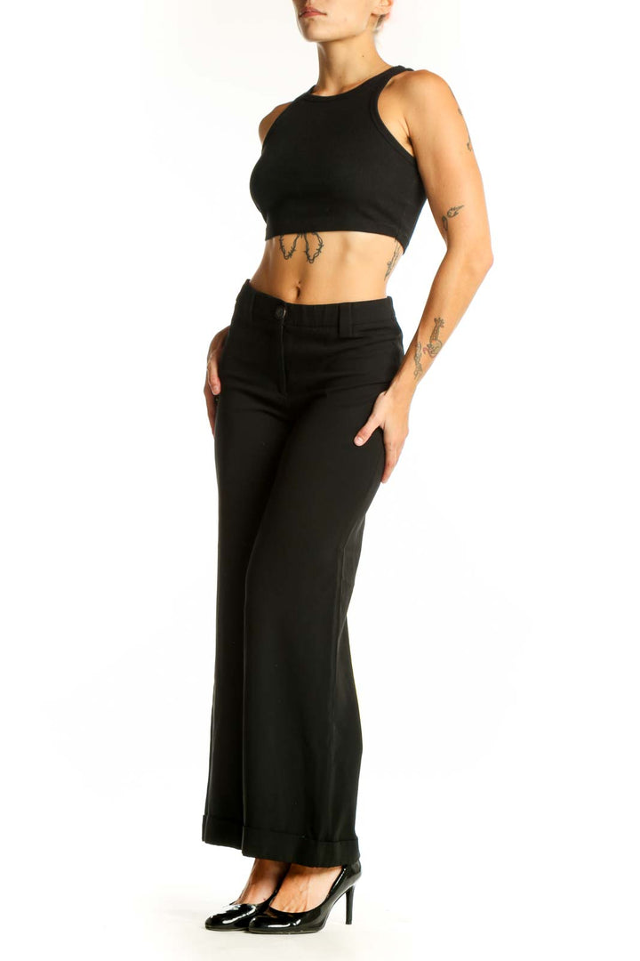 Front view of Moschino black wide-leg trousers on model