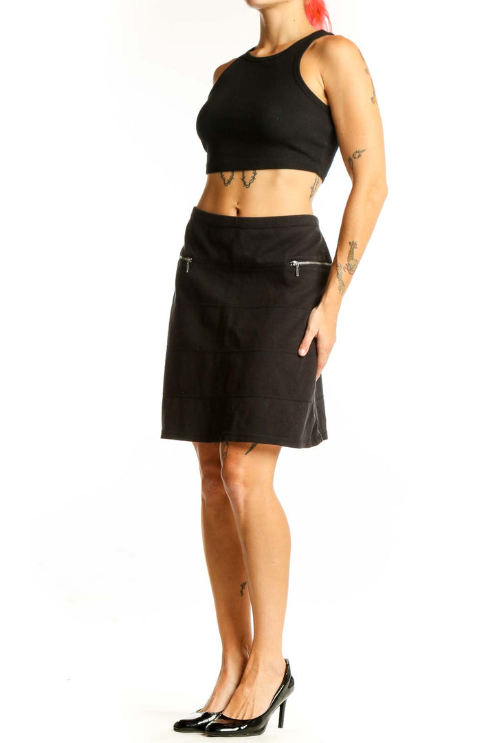Front view of black Athleta A-line skirt with zip pockets