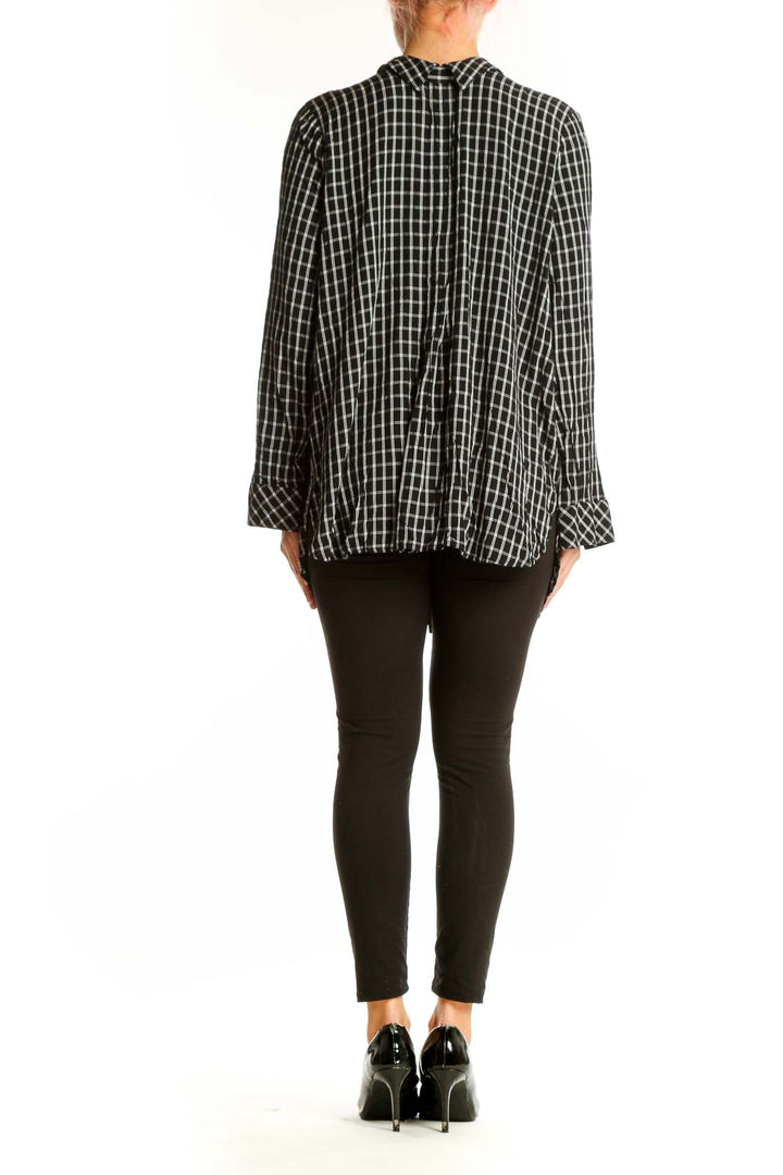 Side view of J.Jill black and white plaid button-up tunic on model
