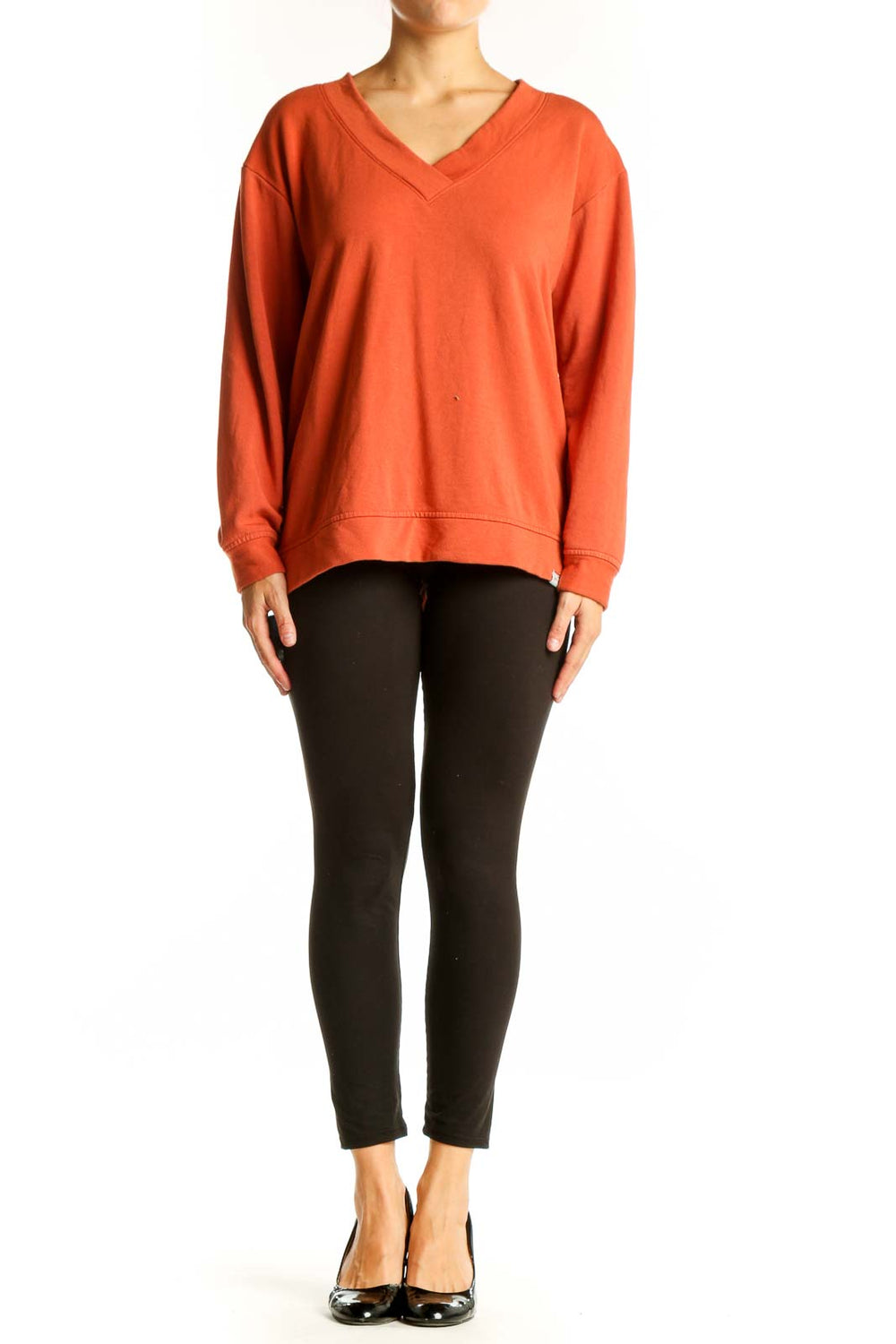 Front view of orange Orvis V-neck long sleeve top on model