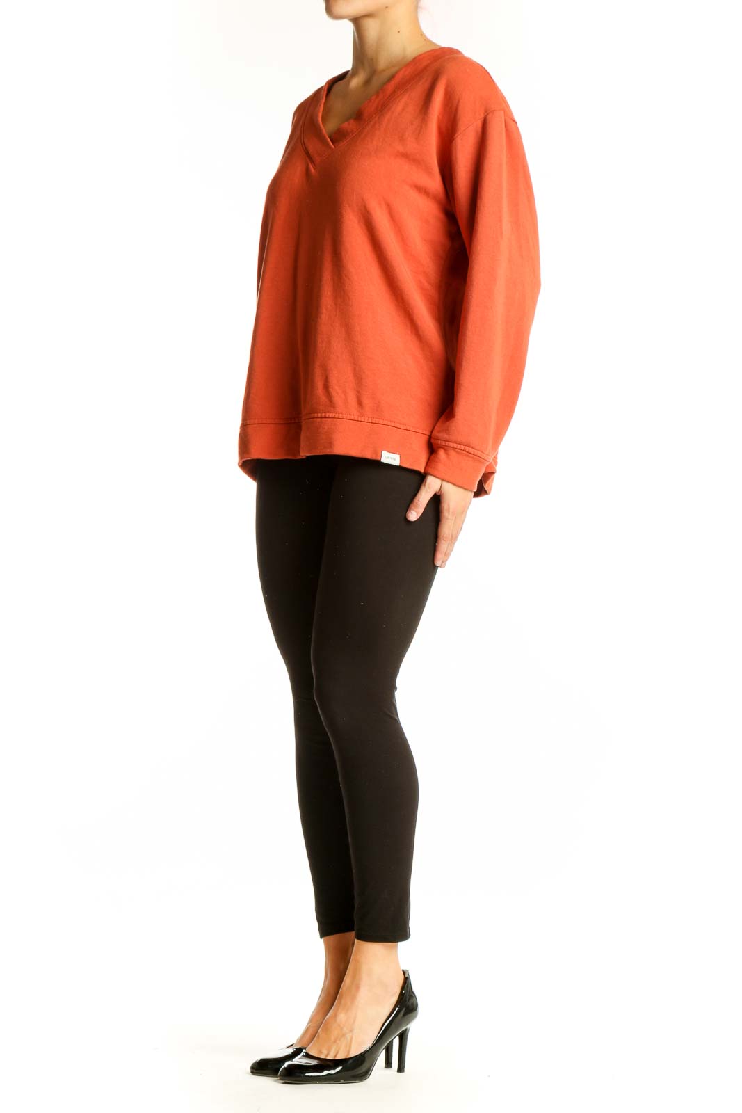 Front view of orange Orvis V-neck long sleeve top on model