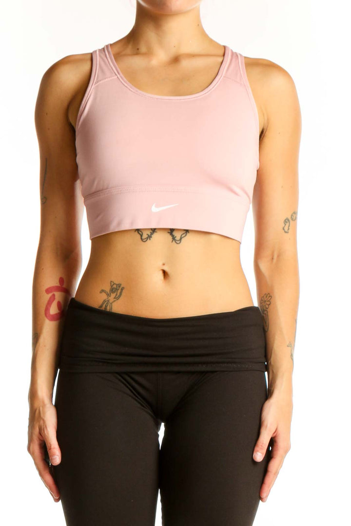 Front view of pink Nike cropped athletic tank top