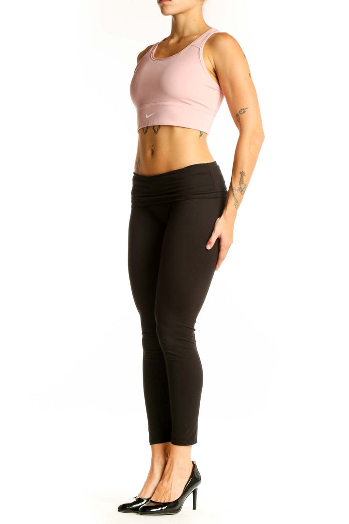 Front view of pink Nike cropped athletic tank top