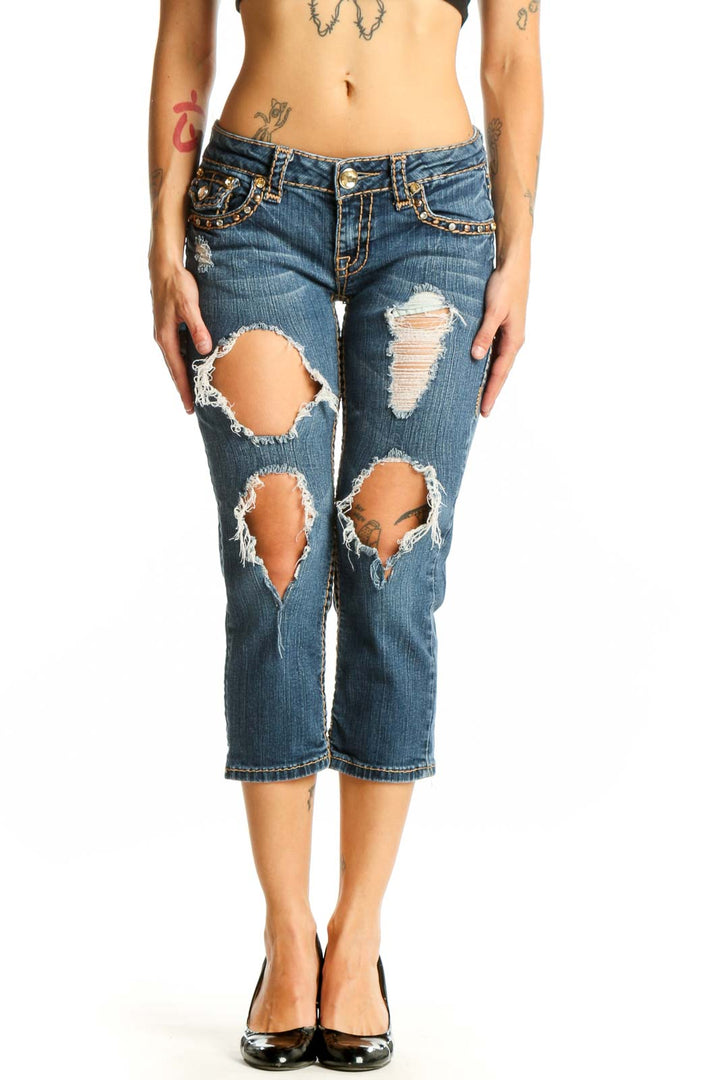 Front view of LA IDOL blue distressed capri jeans with rips and embellishments