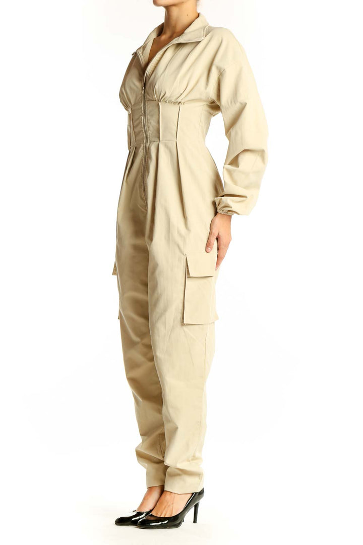 Front view of beige utility jumpsuit with zip-up front and cinched waist