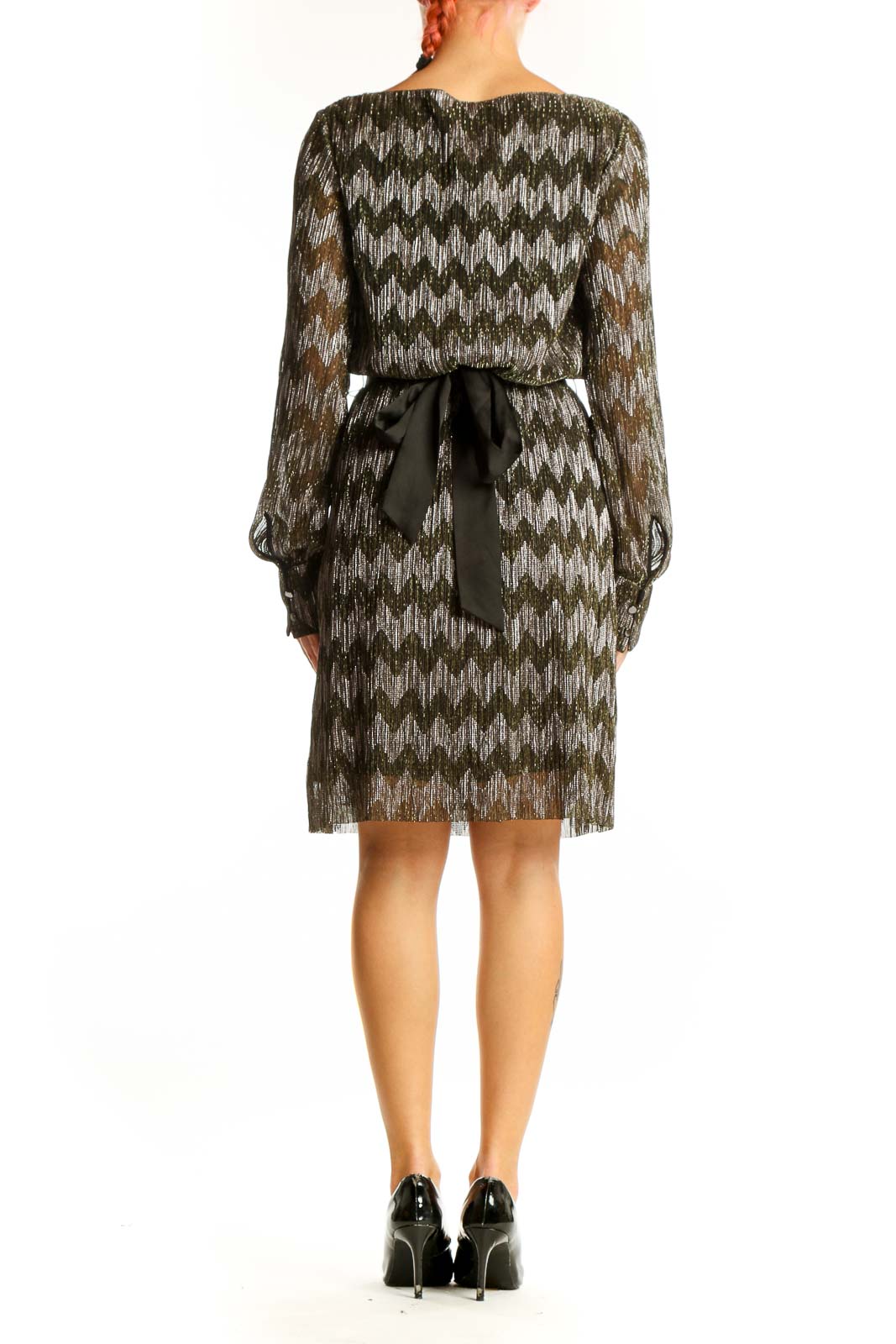 Side view of metallic chevron blouson dress showing long sleeves and knee-length cut