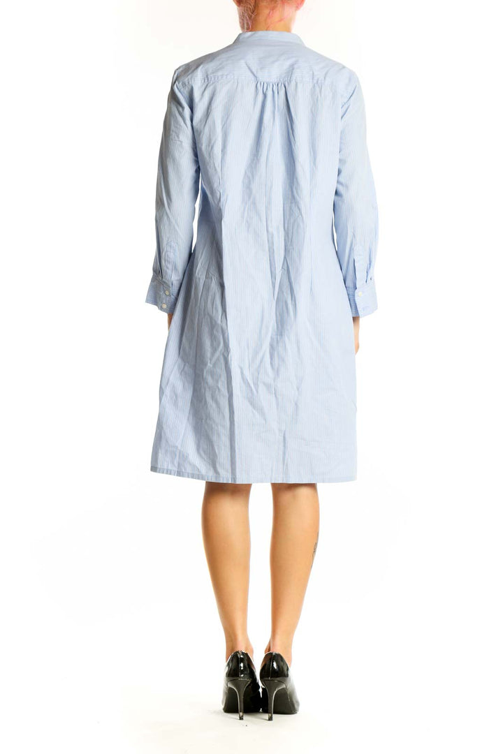 Side view of light blue Trulli cotton shirt dress showing knee-length cut