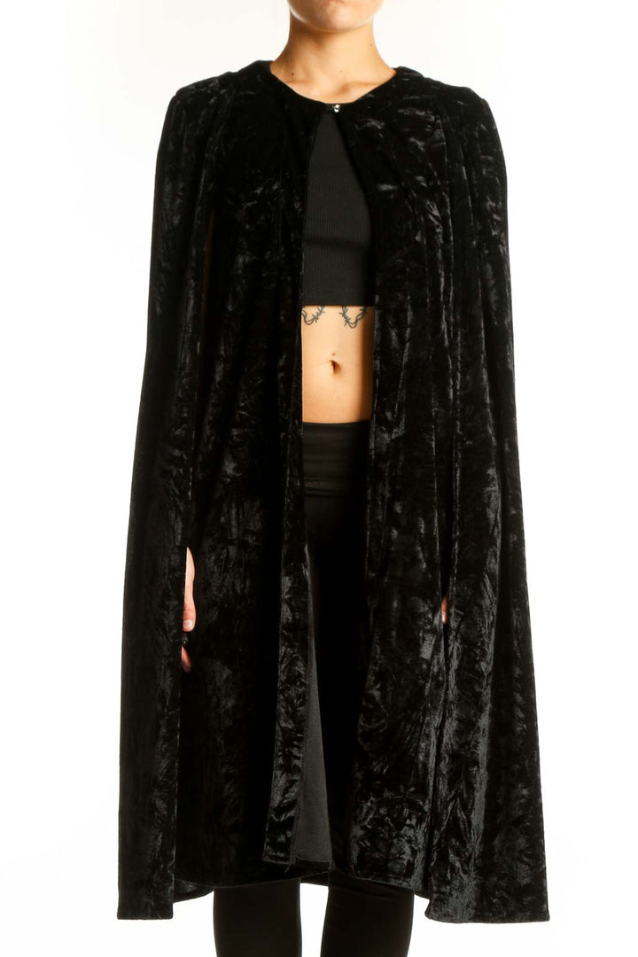 Front view of NastyGal black velvet cape jacket on model
