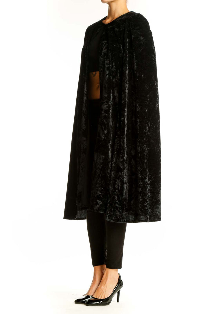 Front view of NastyGal black velvet cape jacket on model