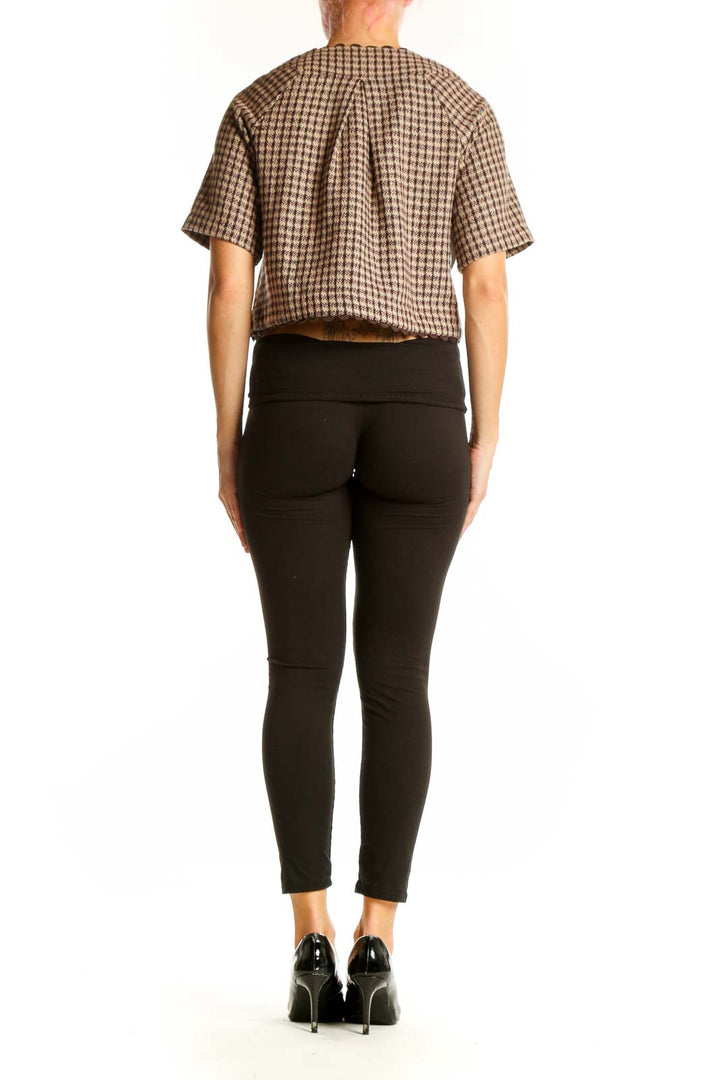 Side view of model wearing Nick & Mo brown houndstooth cropped jacket with black pants