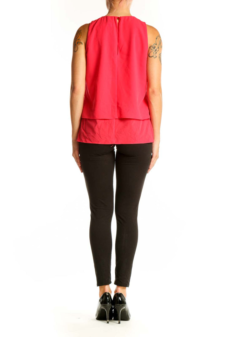 Side view of model wearing red sleeveless layered top from J.Crew with black pants