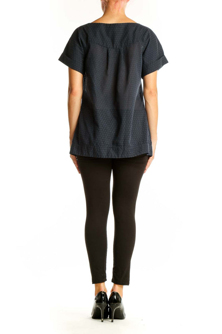 Side view of black textured short-sleeve top by French Connection on model