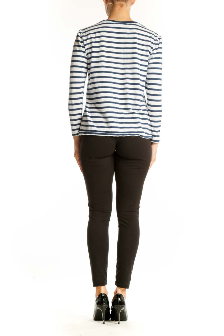 Side view of woman wearing Etre cecile navy striped long sleeve top with black pants