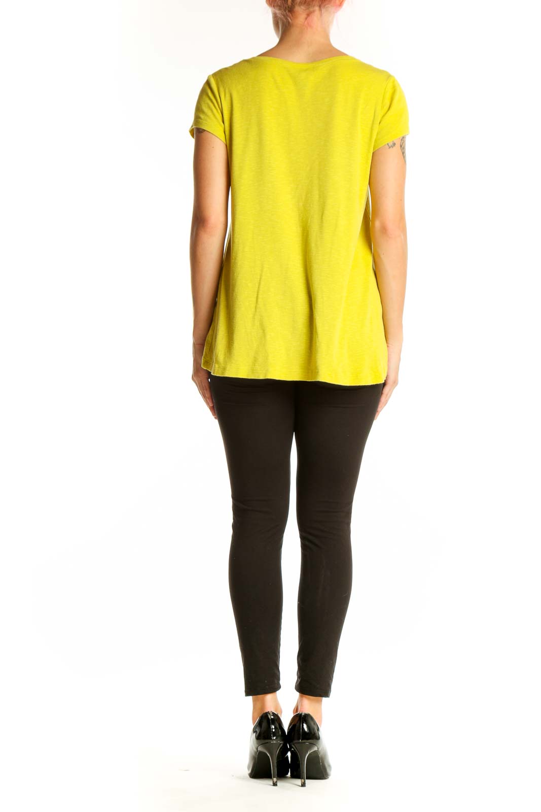 Side view of yellow Cynthia Rowley t-shirt showing relaxed fit and longer back hem