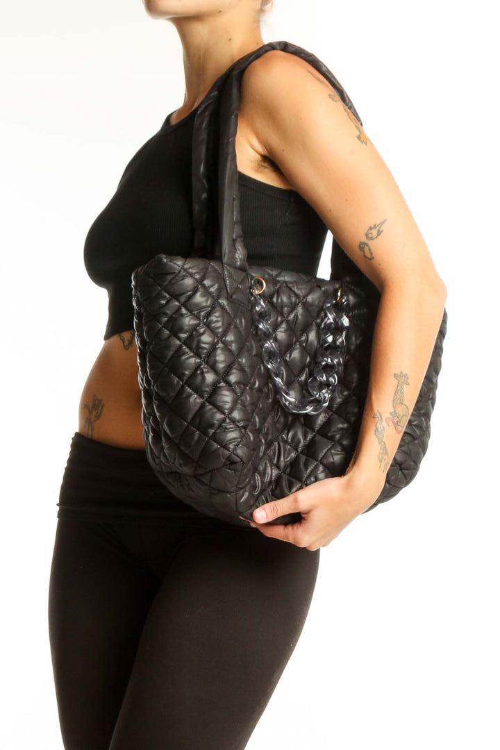 Front view of Jill & Ally black quilted tote bag with long straps