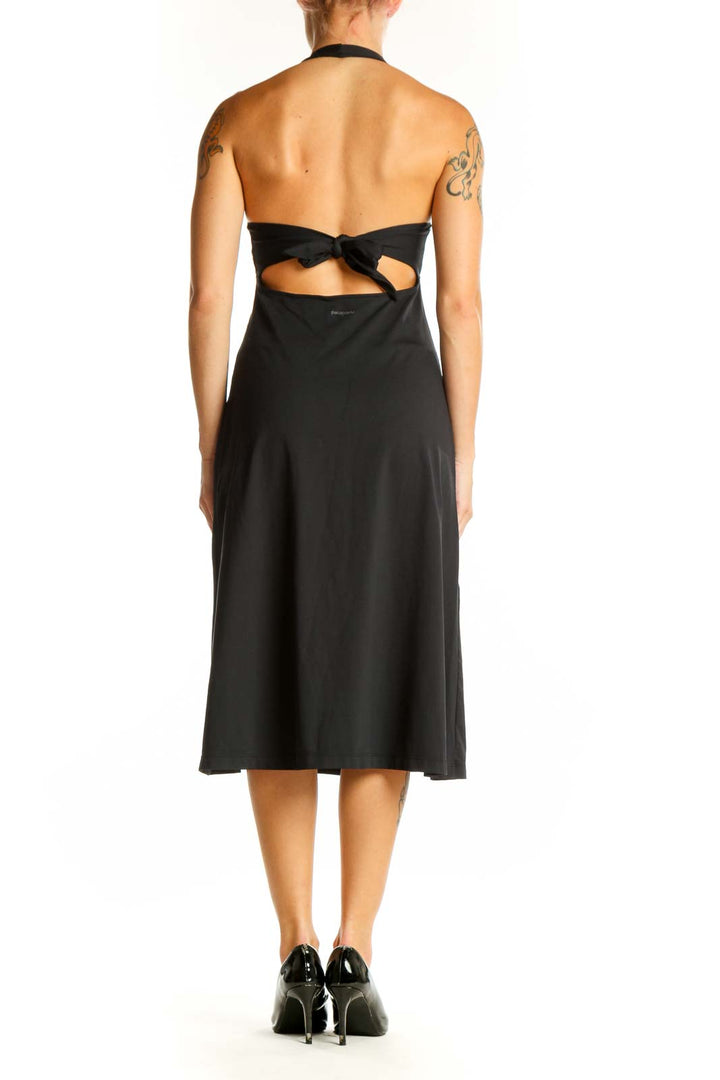 Side view of black Patagonia halter neck midi dress