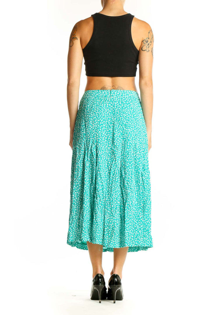 Side view of teal floral print midi skirt from Hobbs London with black crop top