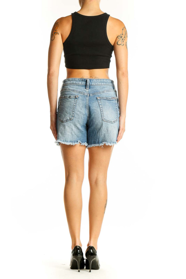 Side view of model wearing Joe's light blue denim shorts with black top