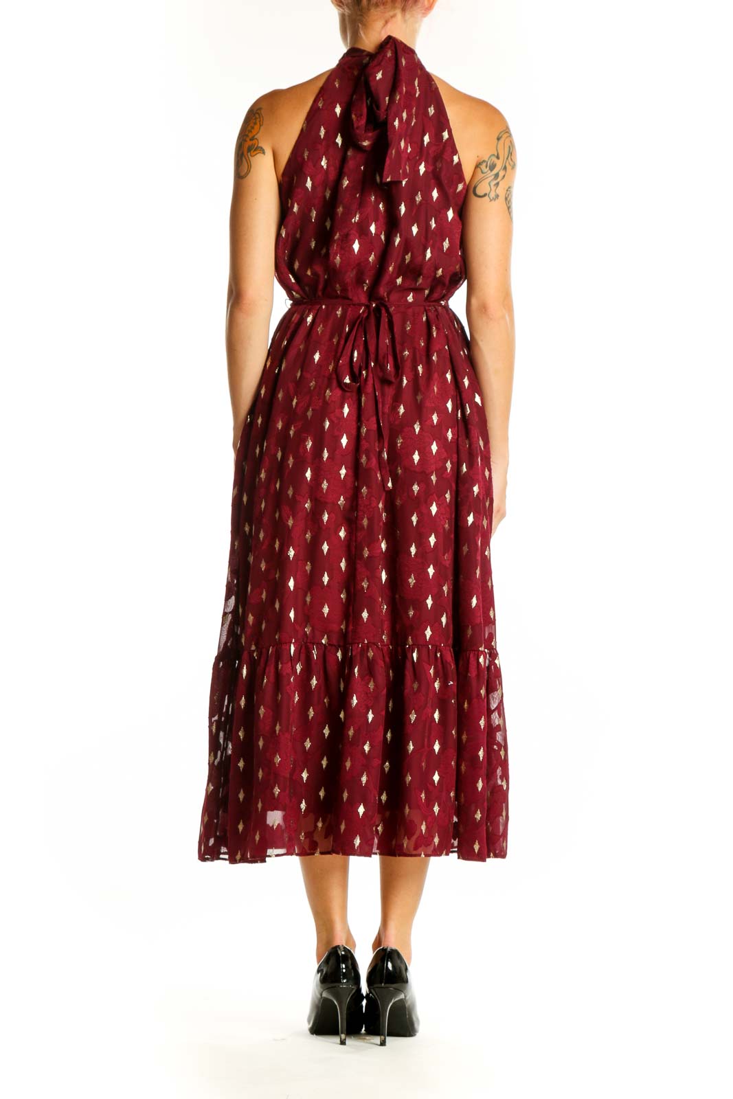 Side view of burgundy halter midi dress showing ruffle hem and cinched waist