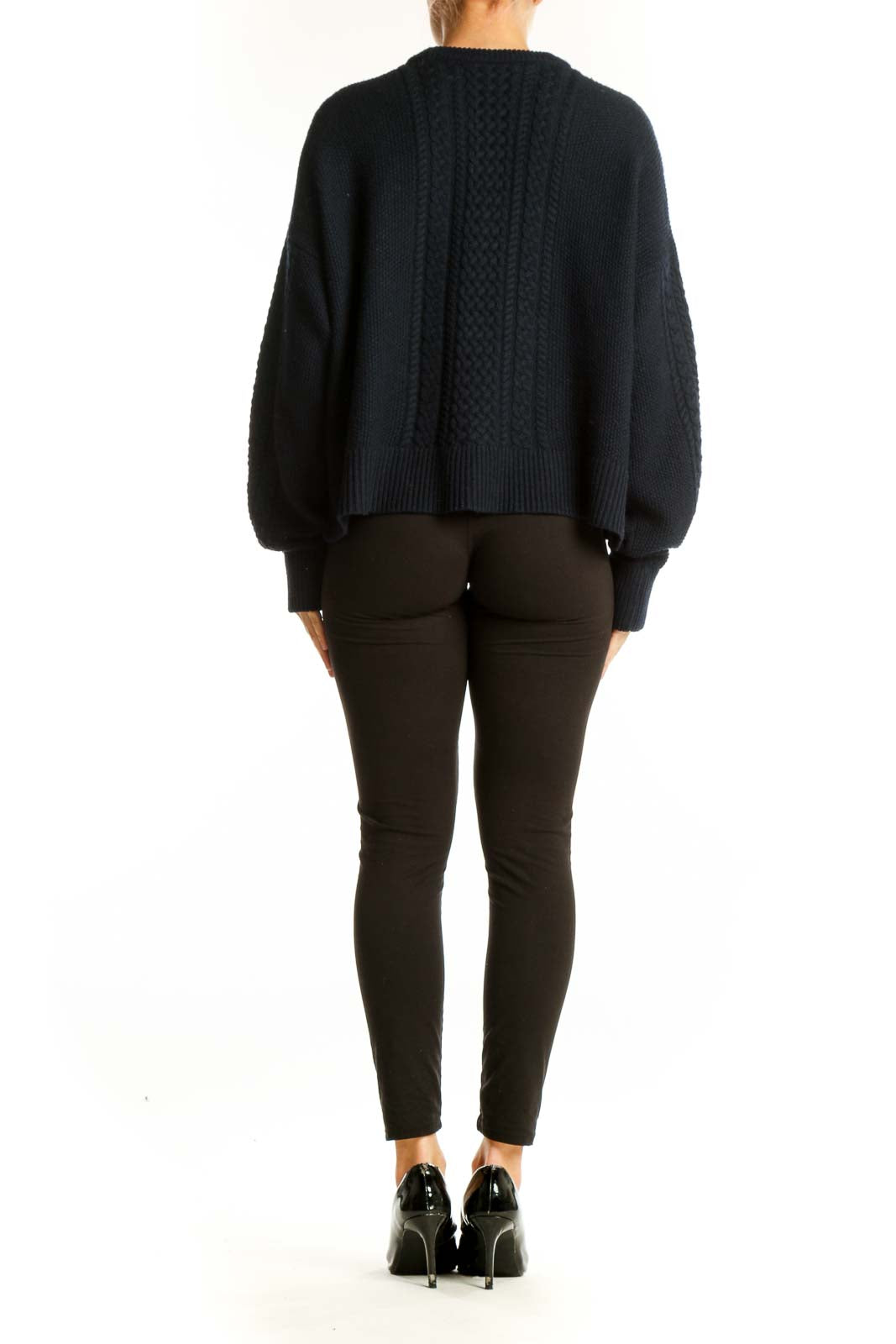 Side view of ATM black cable knit cropped sweater showing relaxed fit and length