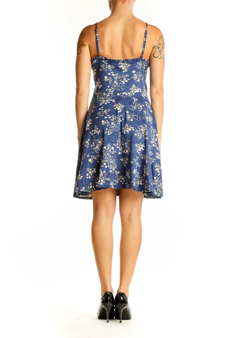 Side view of Nine Britton blue floral spaghetti strap dress showing A-line silhouette