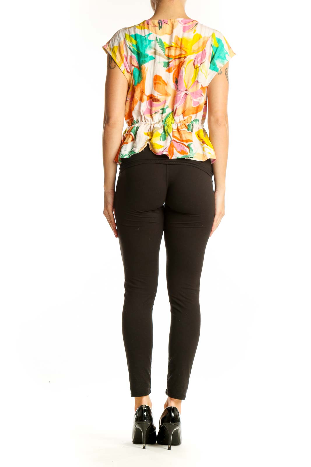 Side view of model wearing Gemma + Jane Multicolor Floral Peplum Top with black pants