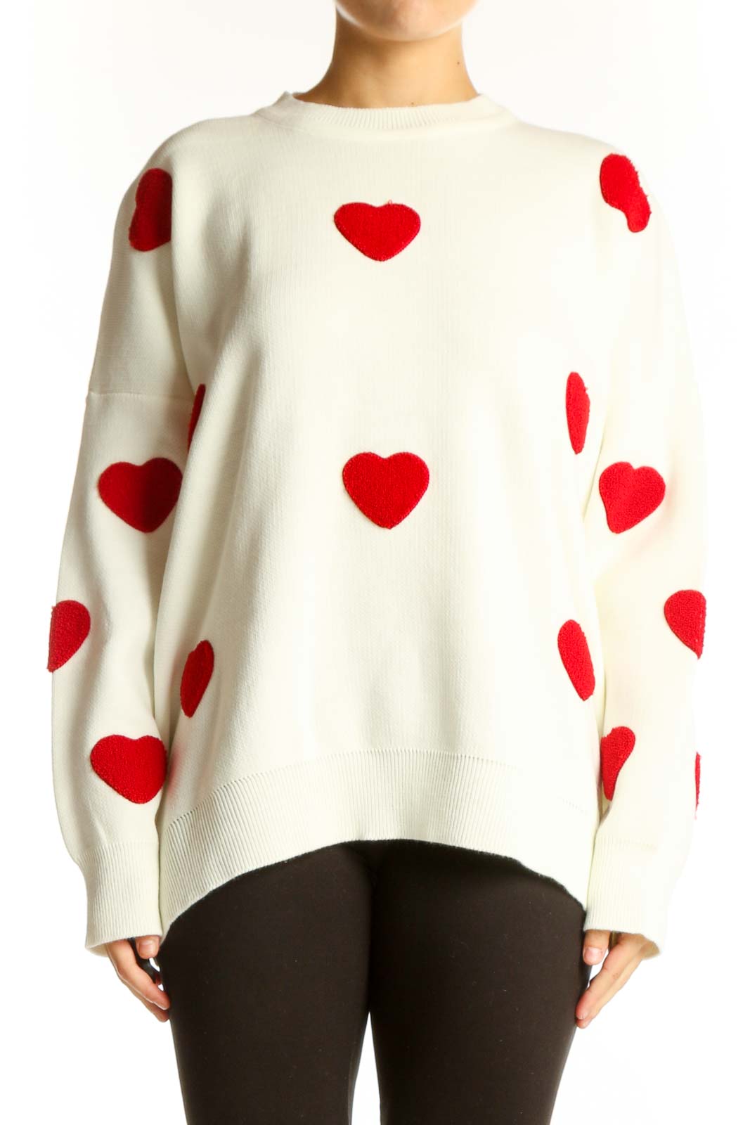 Front view of white oversized sweater with red heart pattern