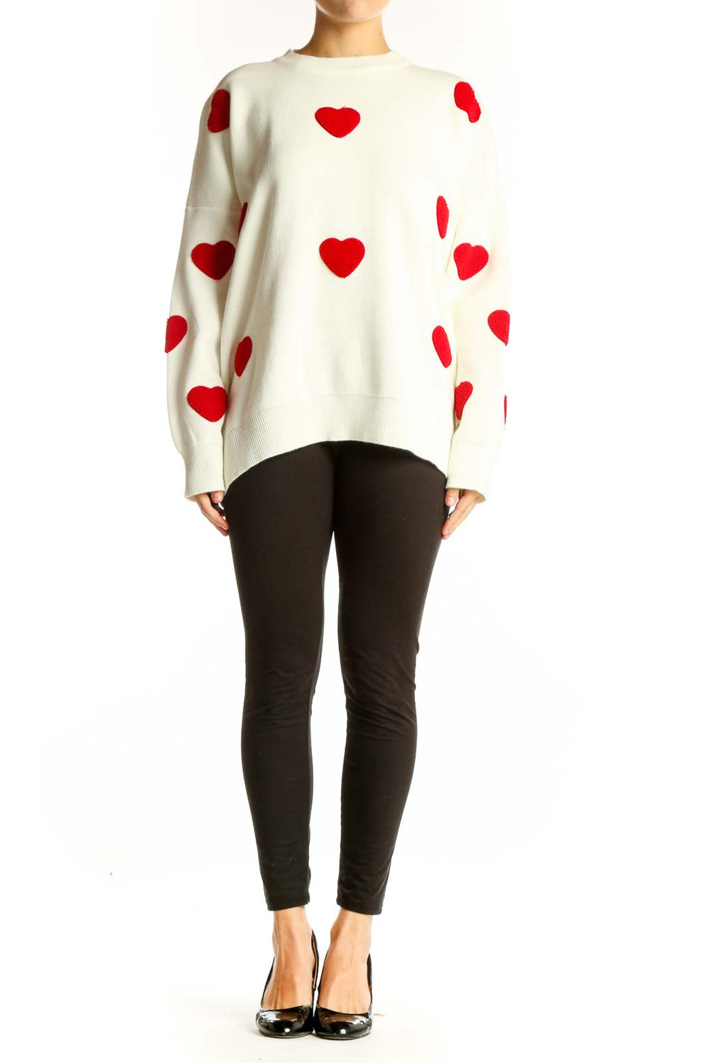 Front view of white oversized sweater with red heart pattern