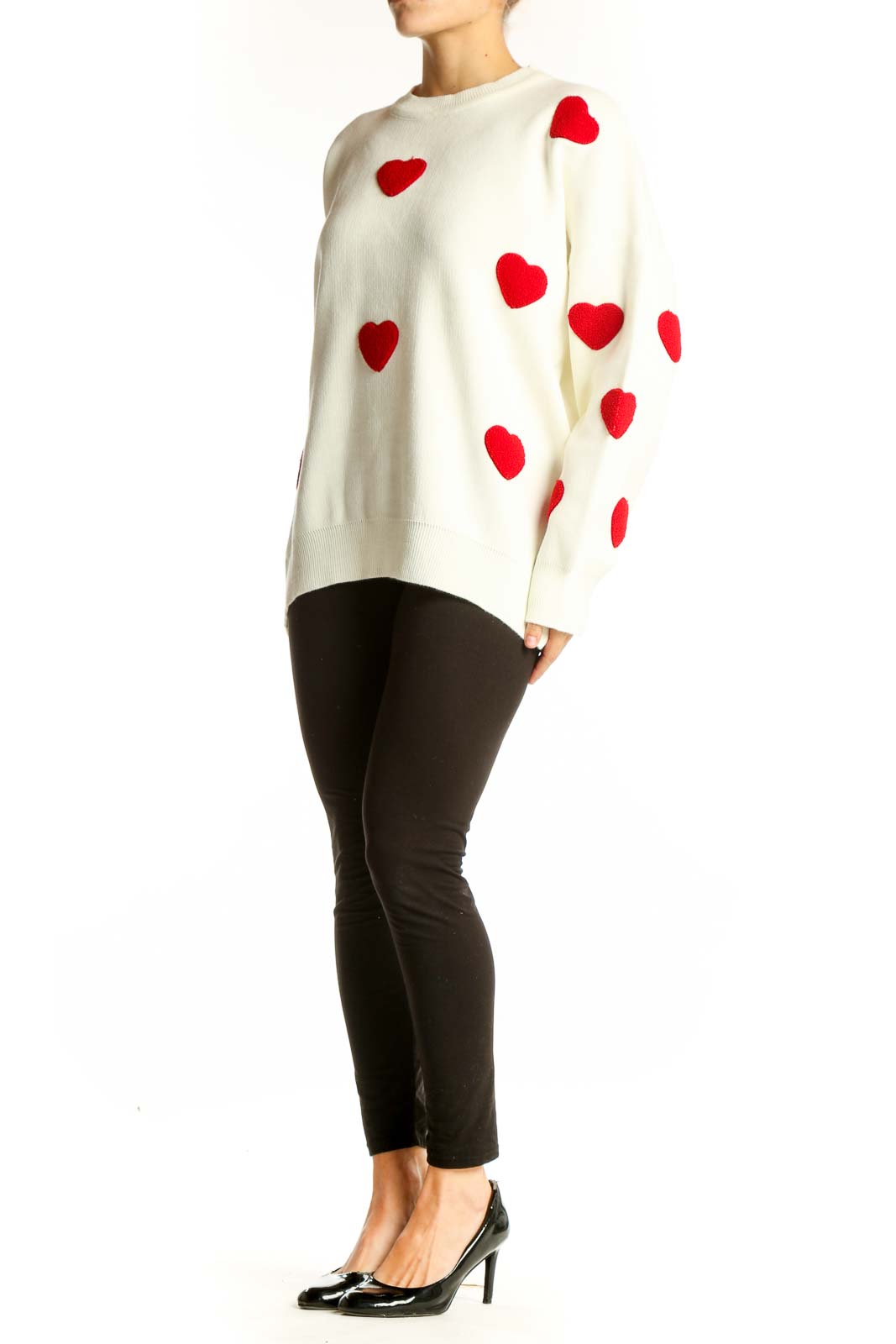 Front view of white oversized sweater with red heart pattern