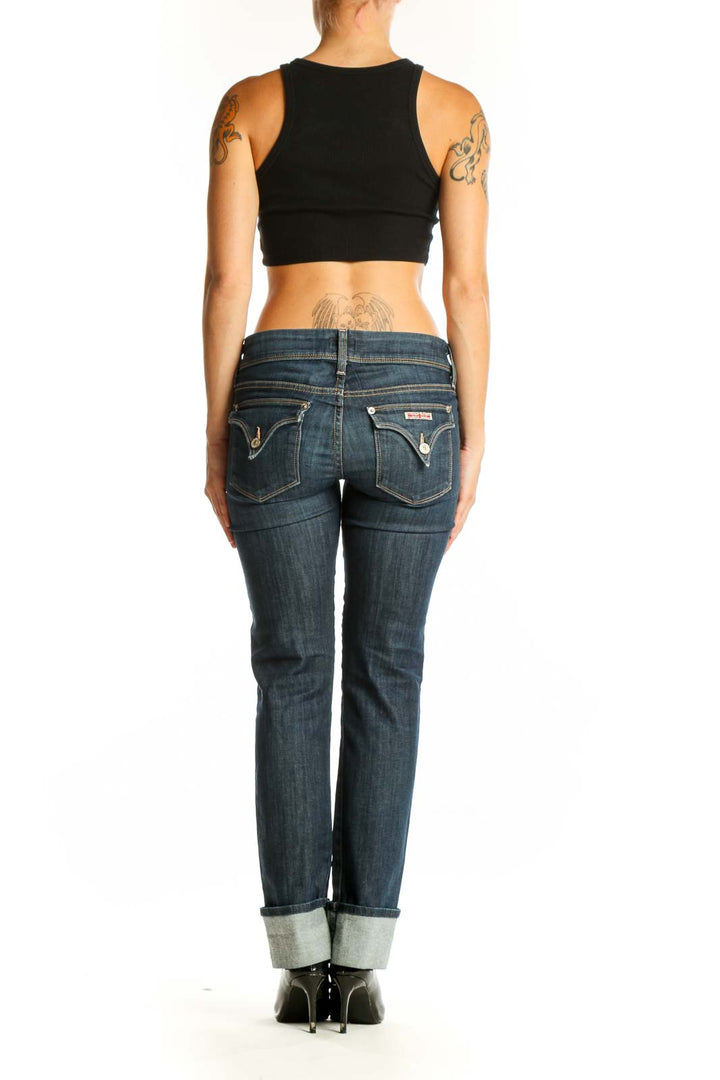 Side view of woman wearing Hudson dark blue straight leg jeans with black top