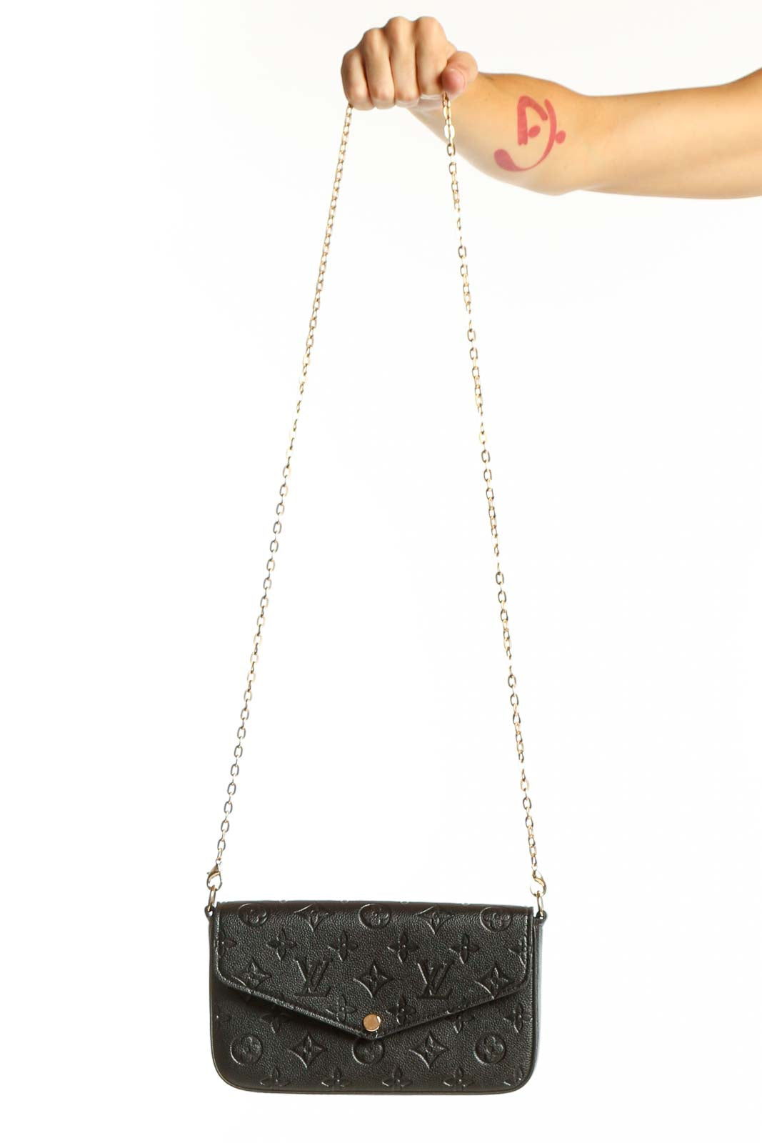 Front view of Louis Vuitton black monogram embossed crossbody bag with gold chain
