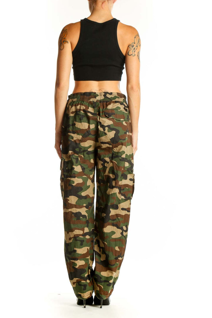 Side view of model wearing Maison Article green camouflage cargo pants