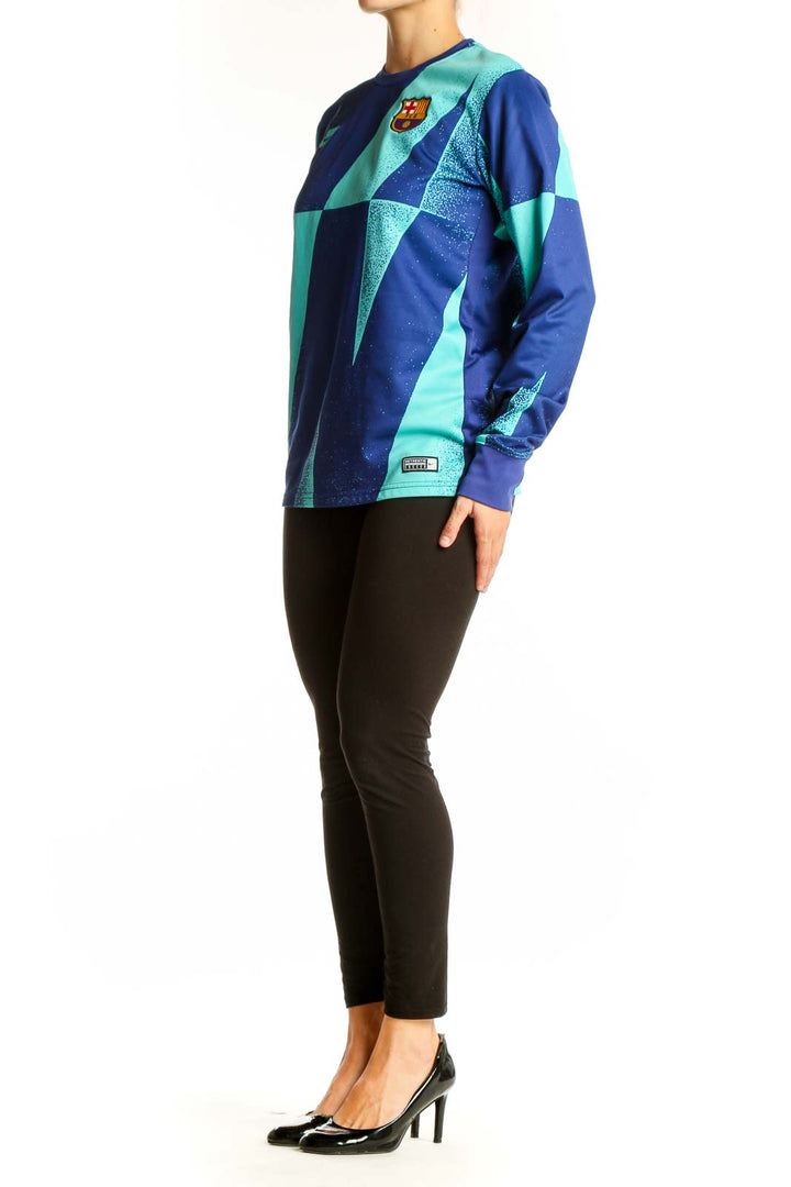Front view of Nike FC Barcelona blue and teal geometric long sleeve athletic top