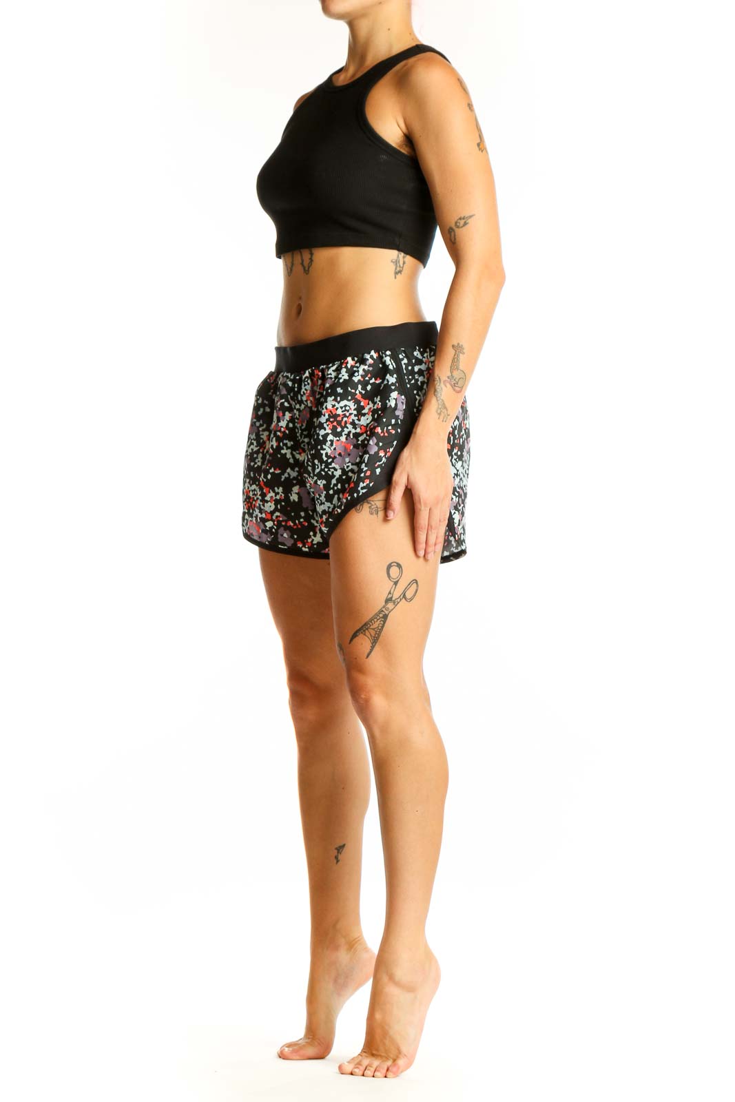 Front view of black floral print Under Armour athletic shorts