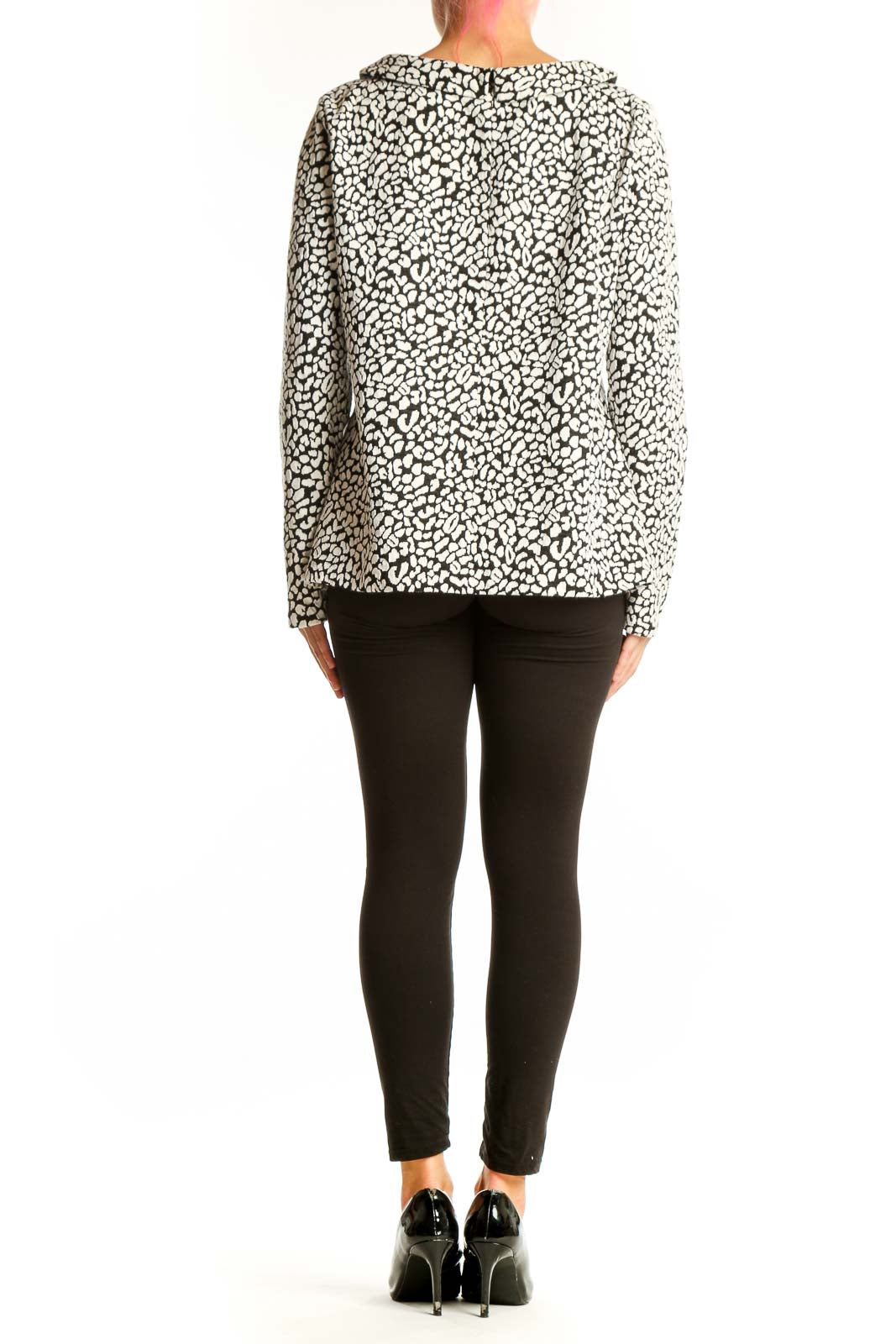 Side view of model wearing Talbots black and white leopard print long sleeve top with black pants