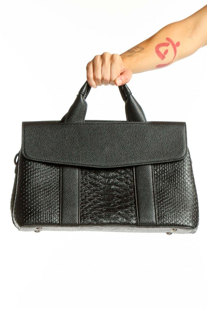 Front view of SilkRoll black leather satchel with textured panels