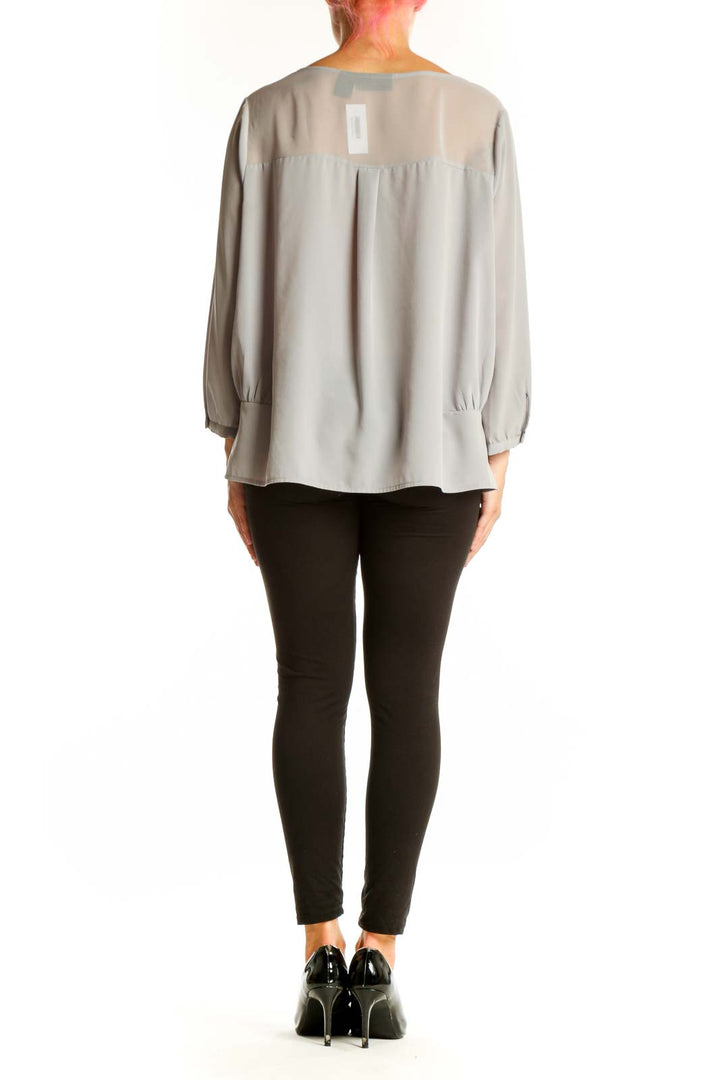 Side view of gray DKNY Jeans polyester blouse showing relaxed fit and length