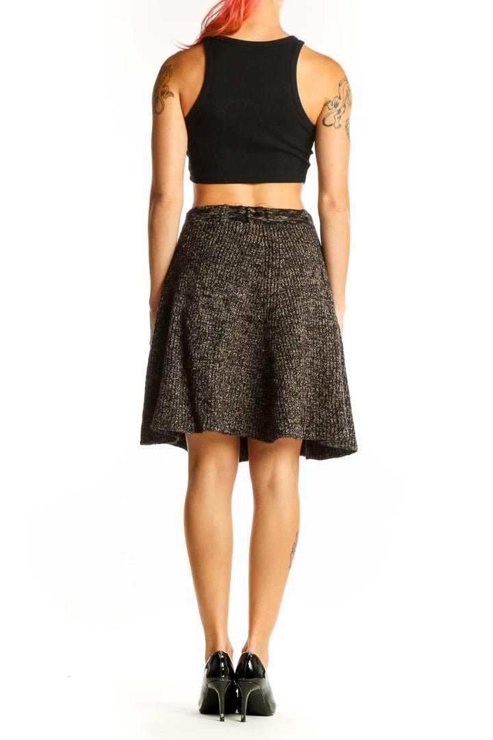 Side view of model wearing Adrienne Vittadini brown ribbed A-line skirt with black top