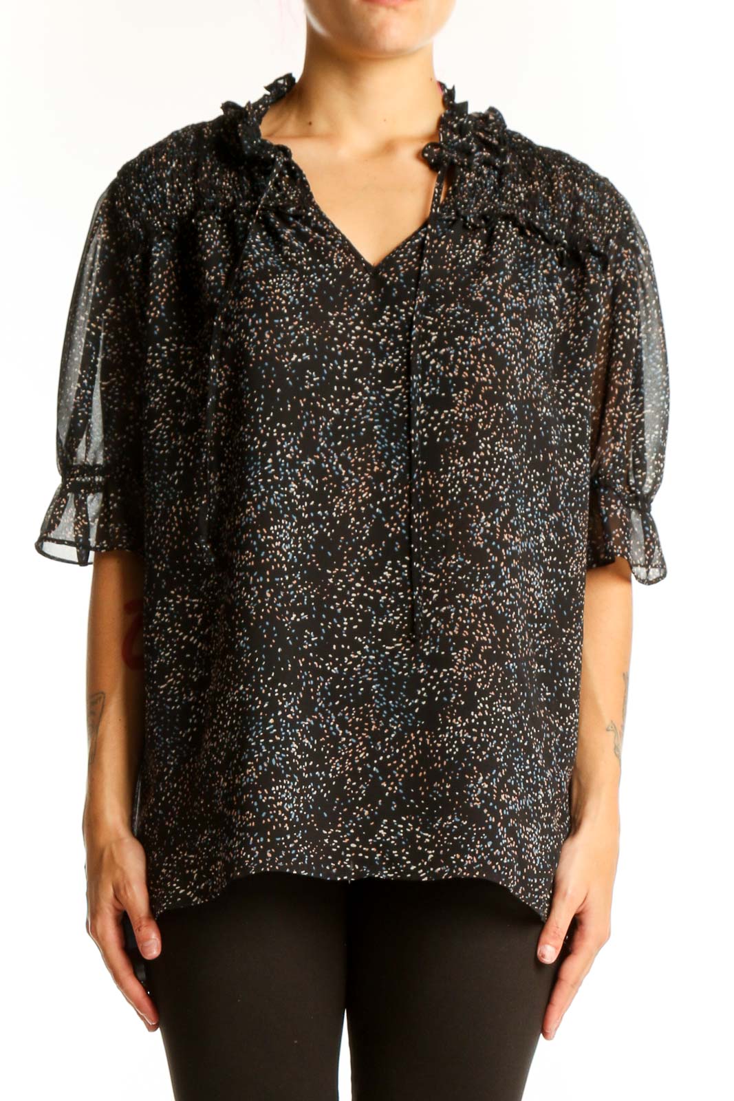 Front view of Pleione black speckled sheer blouse with ruffle-neck