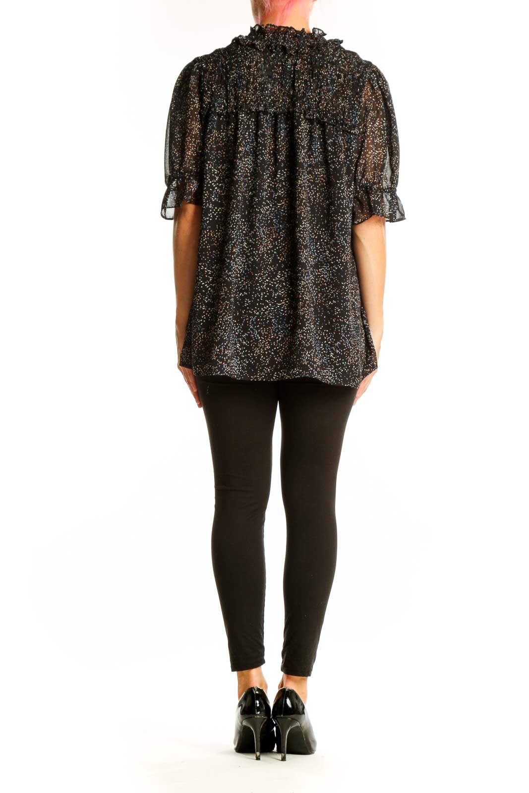 Side view of Pleione black speckled sheer blouse on model