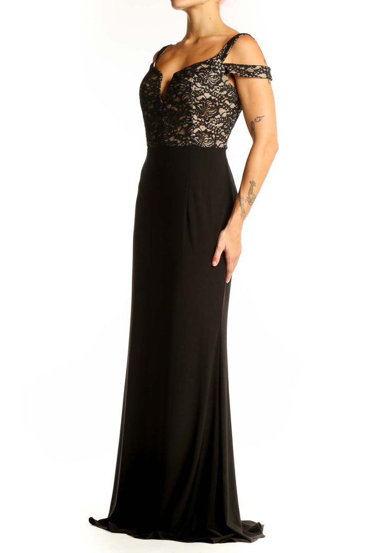 Front view of black lace Xscape evening gown with cold shoulder design