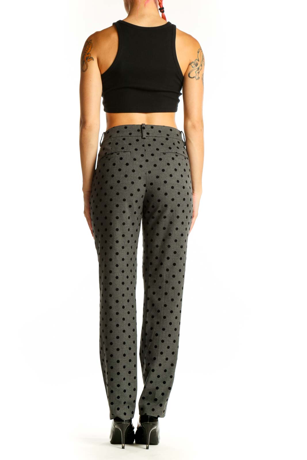 Side view of woman wearing Ann Taylor gray polka dot dress pants