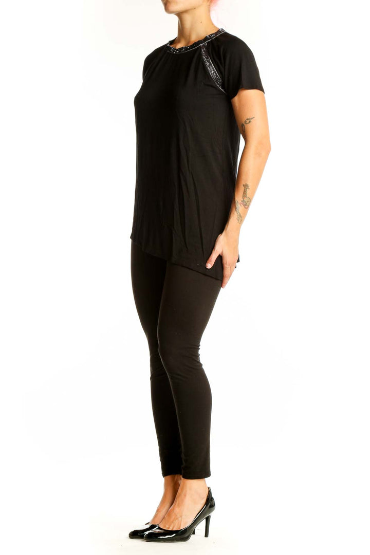 Front view of Design History black asymmetrical short sleeve top with sparkle trim