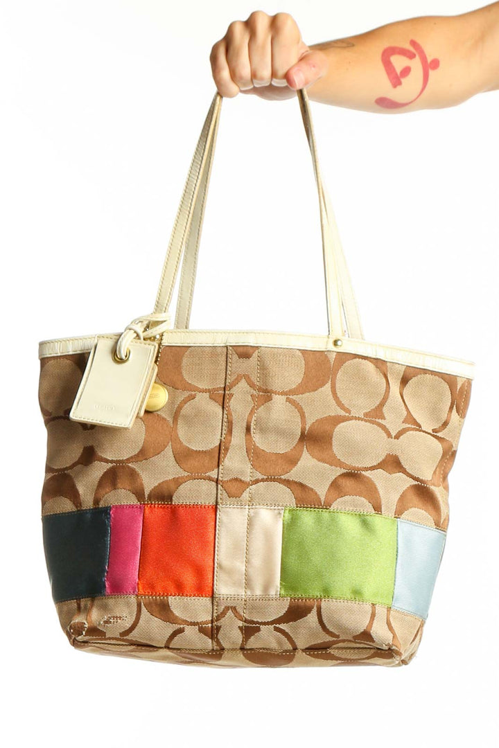 Front view of Coach beige shoulder bag with multicolor stripe detail