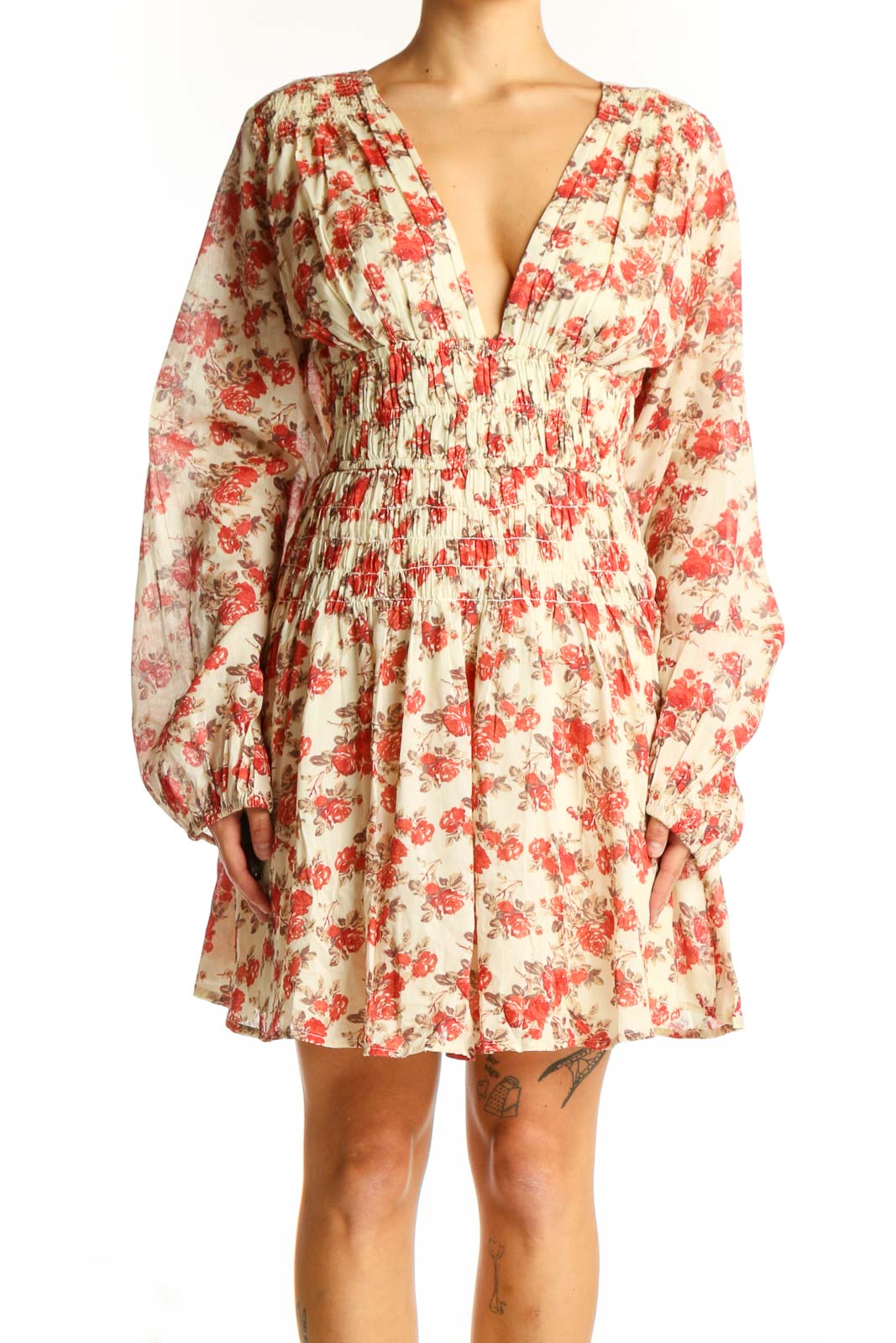 Front view of cream Free People mini dress with red floral print and V-neckline
