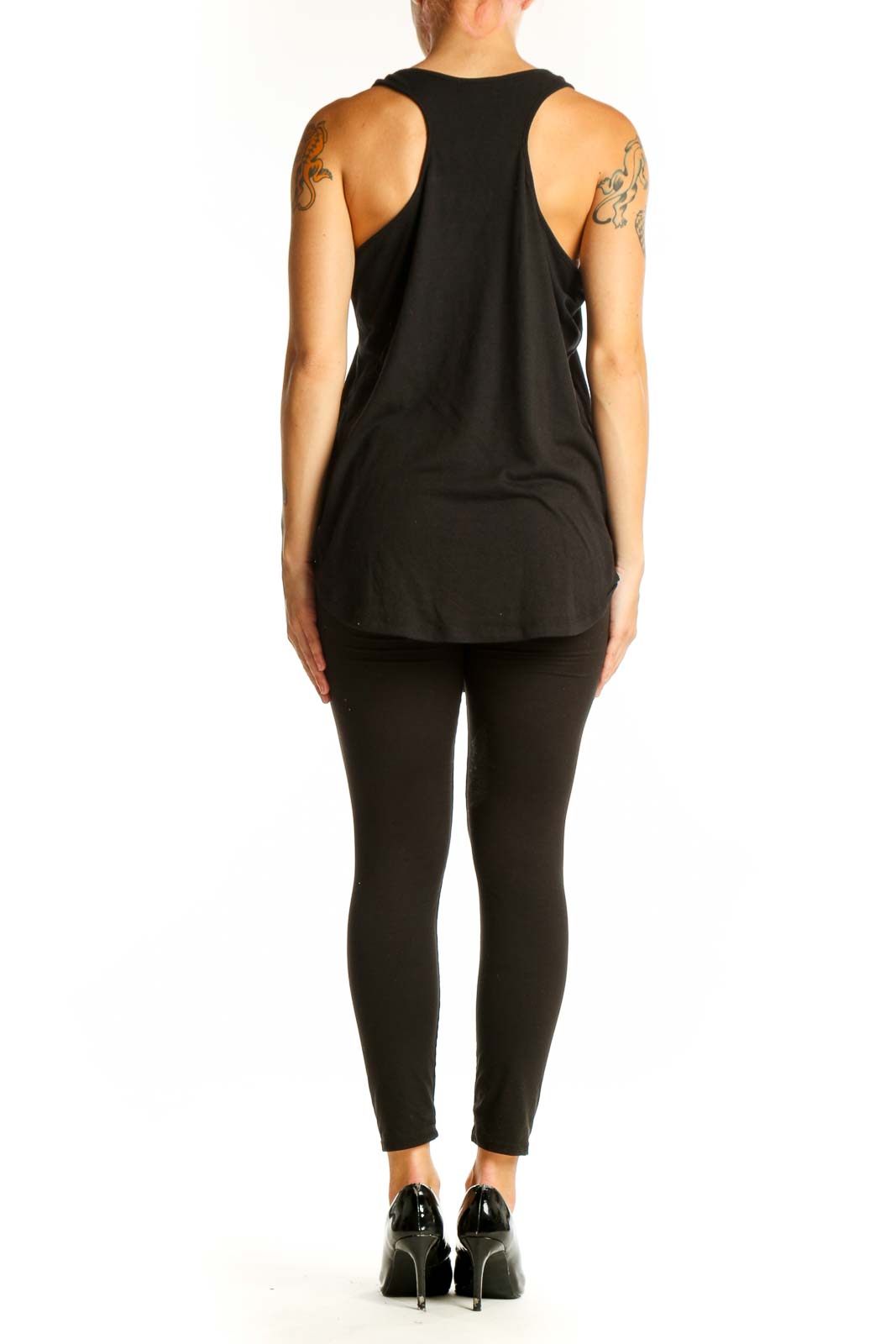 Side view of model wearing black skeleton ribcage graphic tank top
