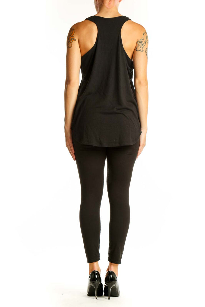 Side view of model wearing black skeleton ribcage graphic tank top