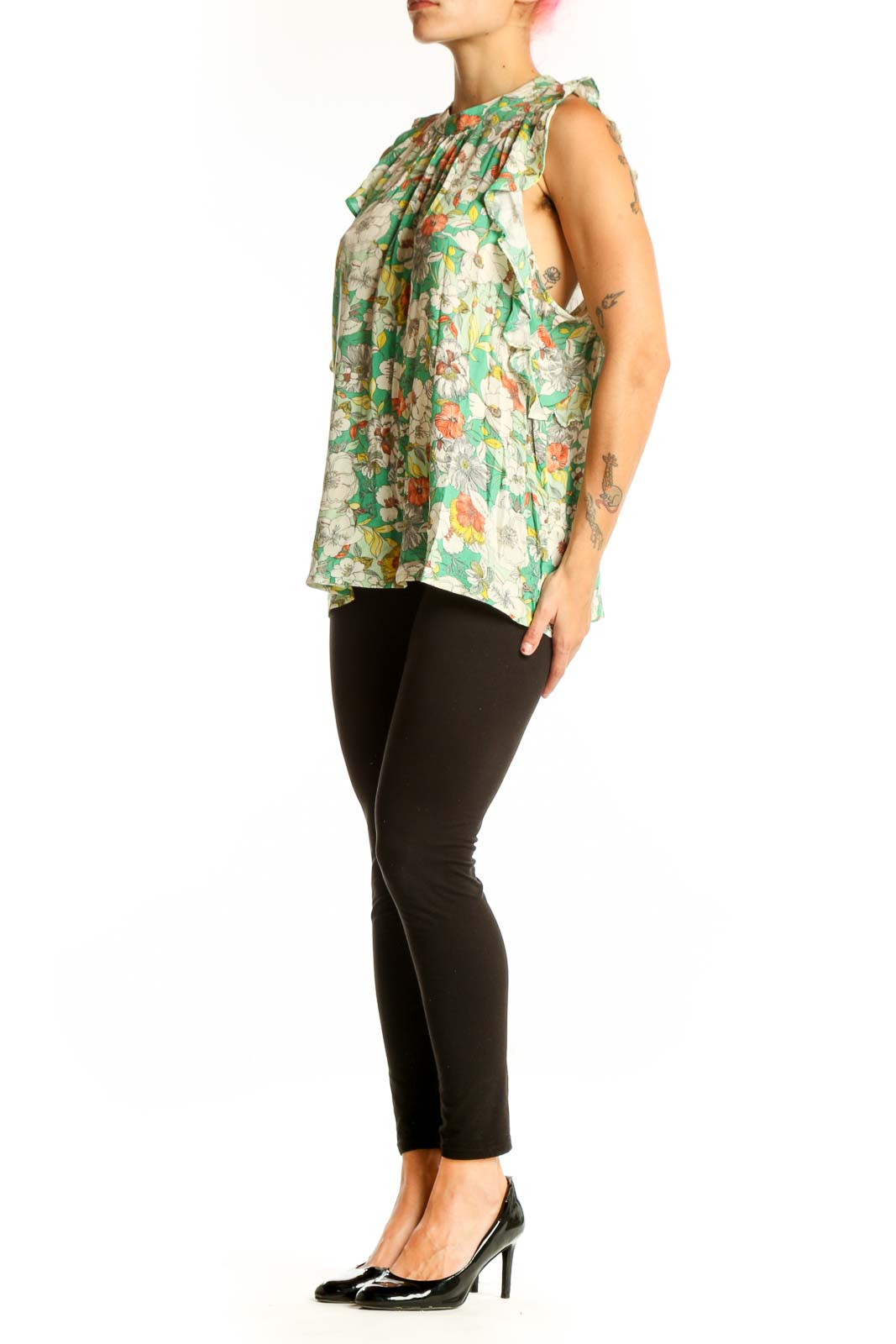 Front view of Anthropologie green floral sleeveless top with ruffle details