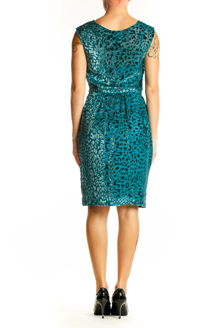 Side view of teal leopard print velvet cocktail dress showing draping and knee-length hem