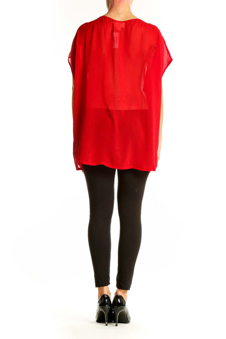 Side view of red asymmetrical pure DKNY top showing flowing silhouette